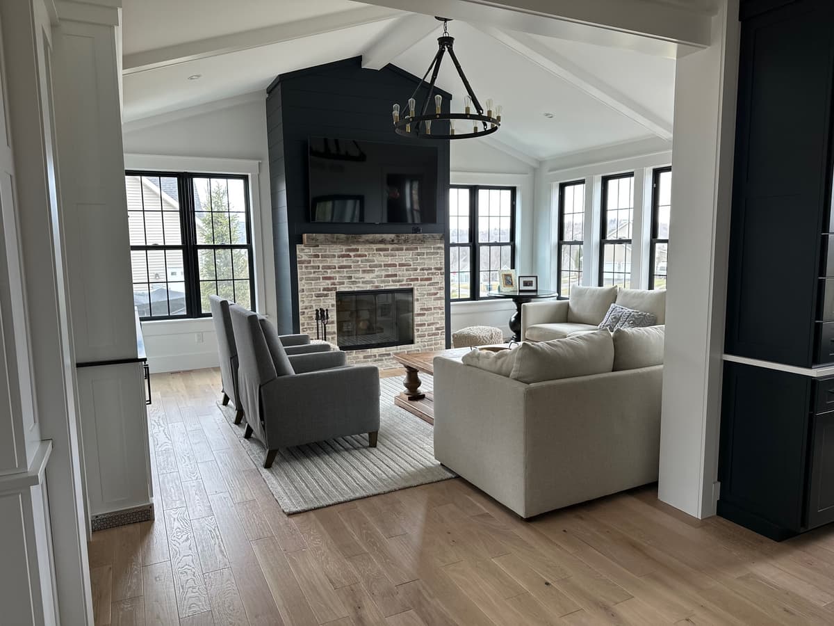 Living room with brick fireplace and vaulted ceiling