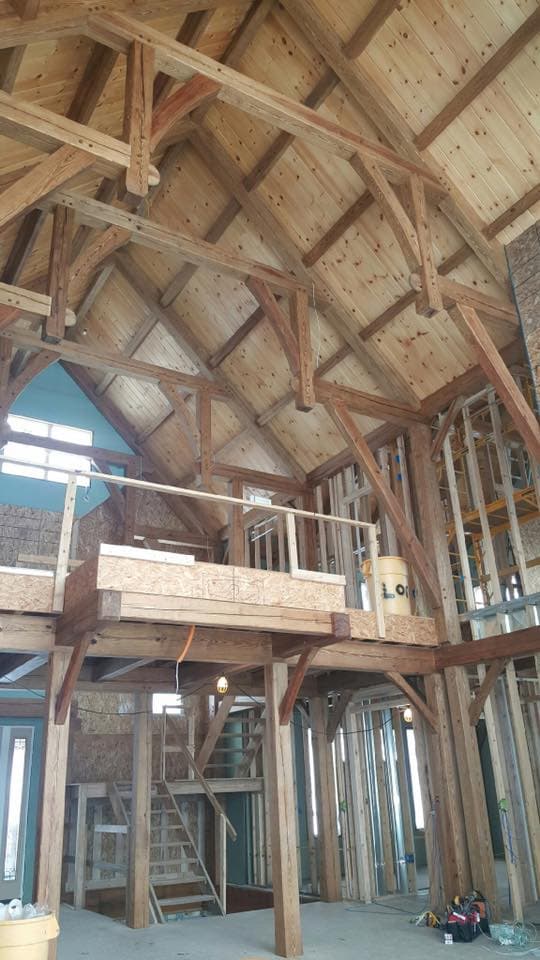 Exposed timber frame with cathedral ceiling and loft during construction