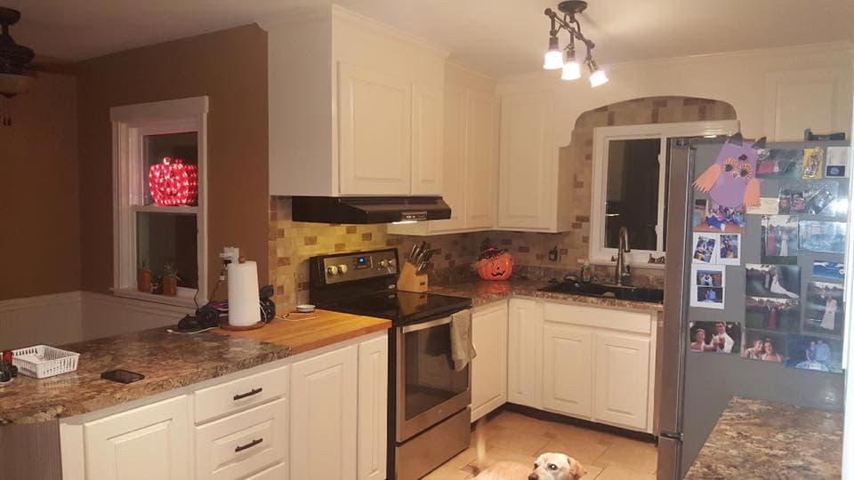 Kitchen with white cabinets, granite countertops, and stainless appliances
